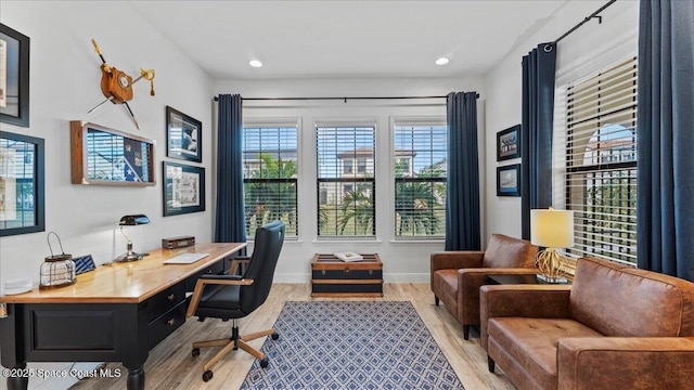 home office featuring light wood finished floors, recessed lighting, and baseboards