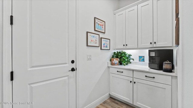 interior space with baseboards and wood finished floors