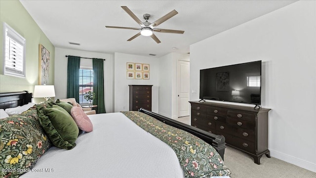 carpeted bedroom with ceiling fan, visible vents, and baseboards