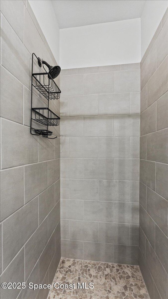 bathroom with a tile shower