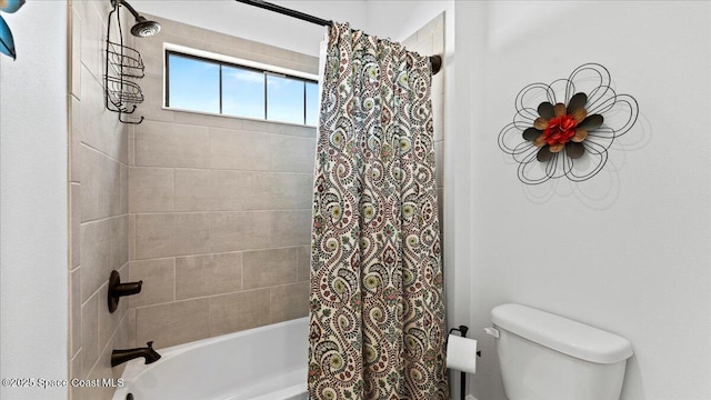 bathroom with shower / bath combination with curtain and toilet