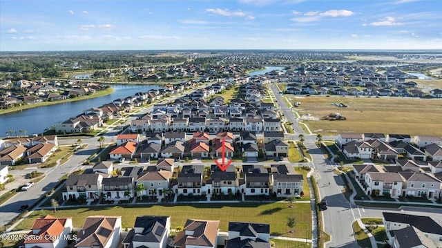 birds eye view of property with a residential view and a water view