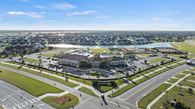 birds eye view of property with a water view and a residential view