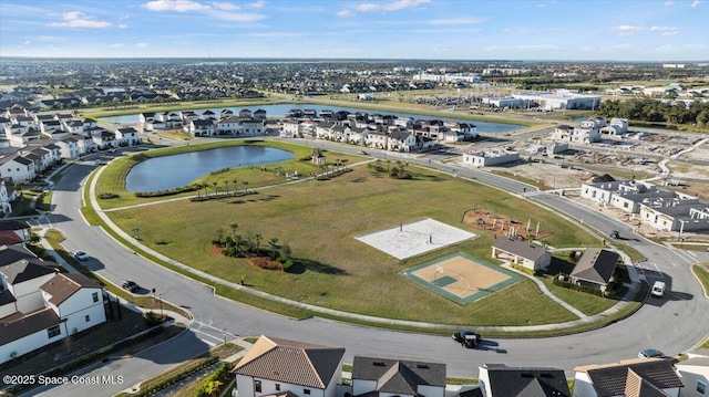 drone / aerial view with a water view and a residential view