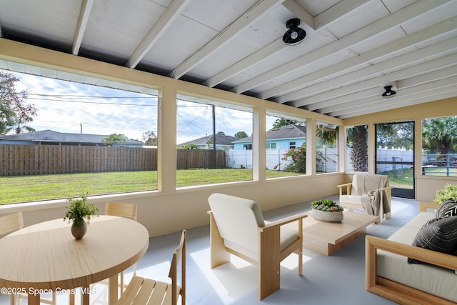 sunroom / solarium with vaulted ceiling with beams