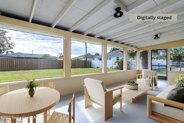 sunroom with vaulted ceiling with beams