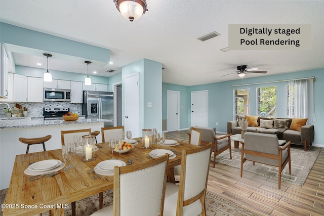 dining space featuring sink and ceiling fan