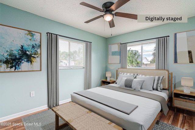 bedroom with wood-type flooring, a textured ceiling, and ceiling fan