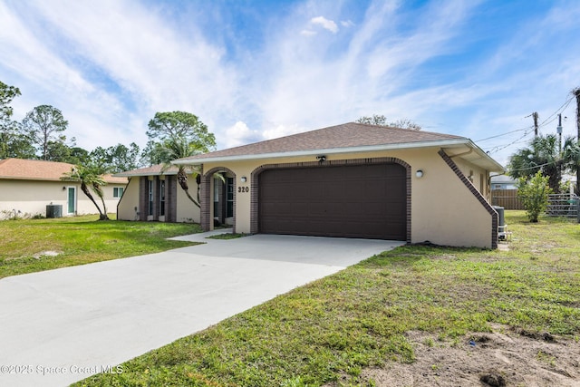 ranch-style house with a garage, a front yard, and central air condition unit