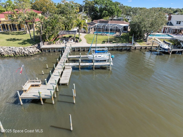 view of dock with a water view, a yard, and glass enclosure