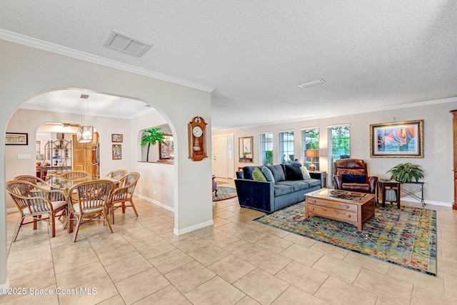 tiled living room featuring ornamental molding and a textured ceiling