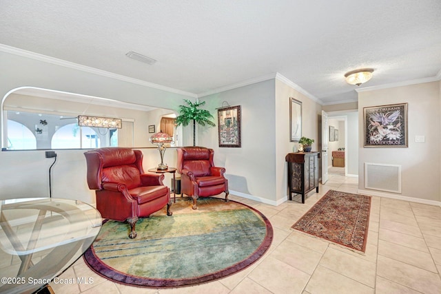 sitting room with ornamental molding, a textured ceiling, and light tile patterned flooring