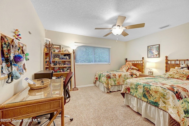 carpeted bedroom with ceiling fan and a textured ceiling