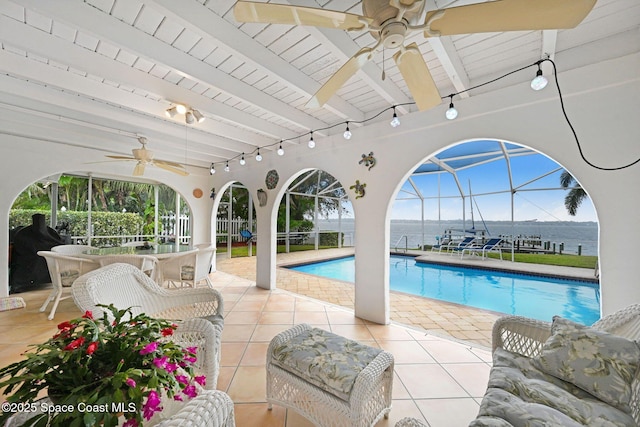 view of swimming pool featuring a water view, outdoor lounge area, ceiling fan, and a patio area