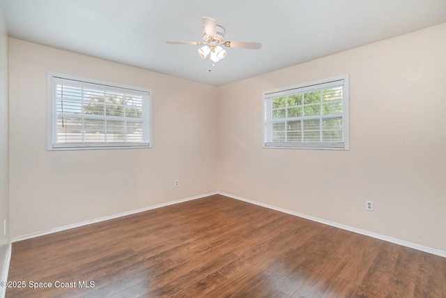 empty room with ceiling fan and dark hardwood / wood-style floors