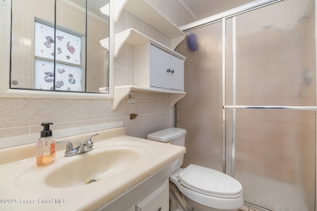 bathroom with decorative backsplash, walk in shower, vanity, and toilet