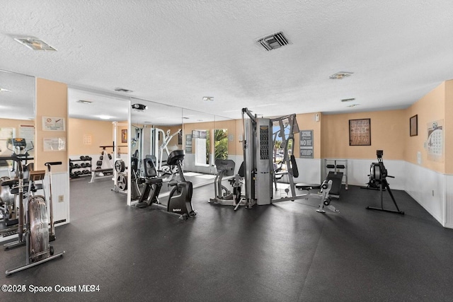 exercise room featuring a textured ceiling