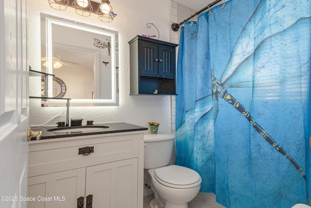 bathroom featuring vanity, a shower with shower curtain, and toilet