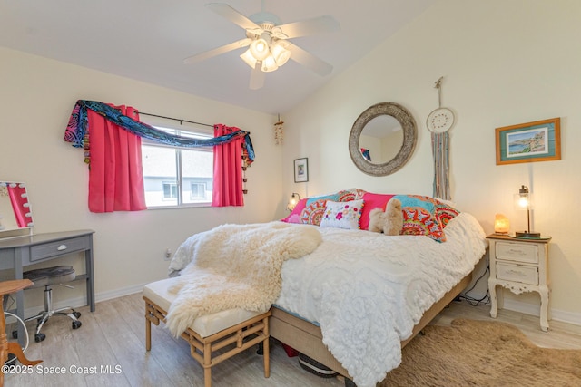 bedroom featuring light hardwood / wood-style flooring, ceiling fan, and vaulted ceiling