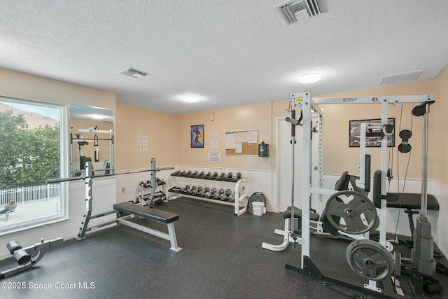 exercise room with a textured ceiling