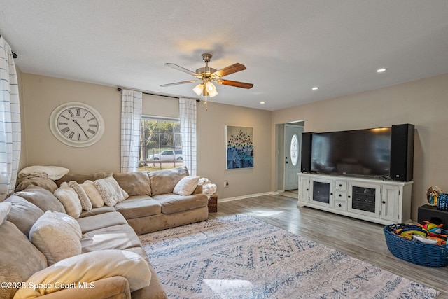 living room featuring a textured ceiling, recessed lighting, wood finished floors, a ceiling fan, and baseboards