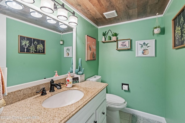 bathroom with toilet, vanity, visible vents, and ornamental molding