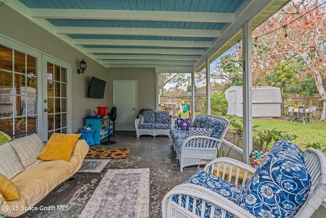 sunroom with vaulted ceiling with beams and french doors