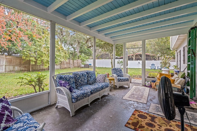 sunroom / solarium featuring a healthy amount of sunlight and beam ceiling