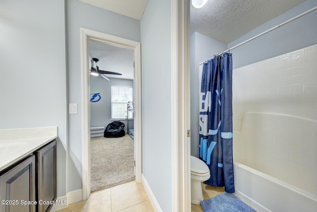 full bathroom with tile patterned flooring, vanity, toilet, shower / bathtub combination with curtain, and a textured ceiling