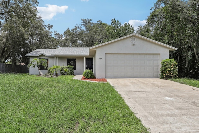 single story home featuring a garage and a front lawn