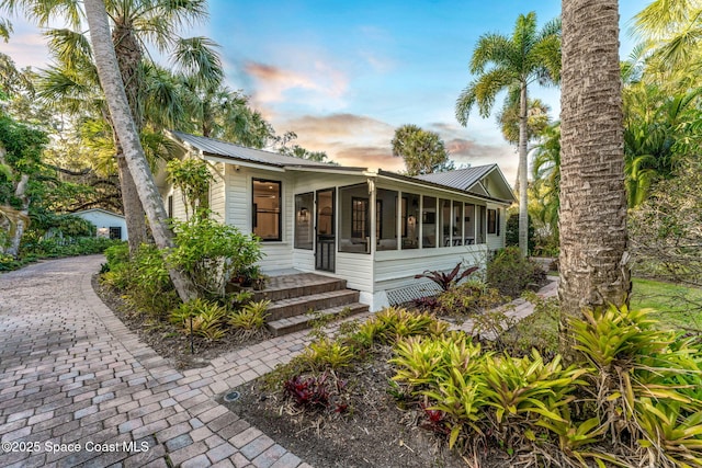 view of front of property featuring a sunroom