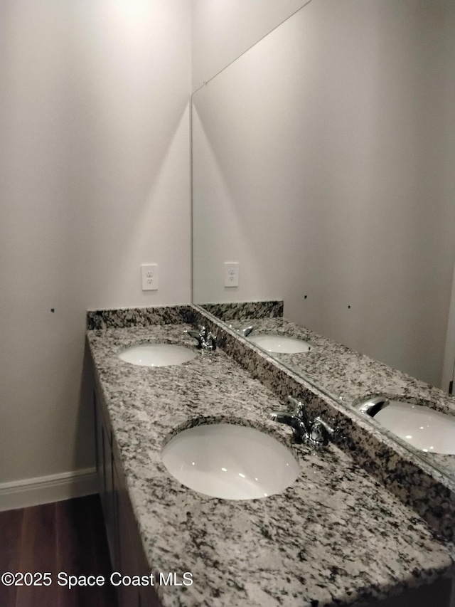 bathroom featuring hardwood / wood-style flooring and vanity