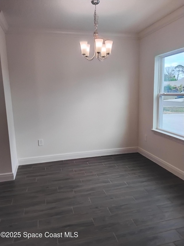 unfurnished room featuring crown molding, dark hardwood / wood-style flooring, and a notable chandelier