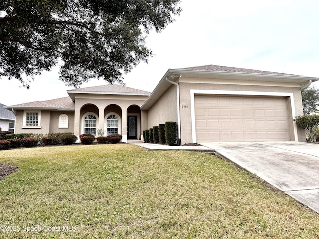 view of front of property with a garage and a front yard