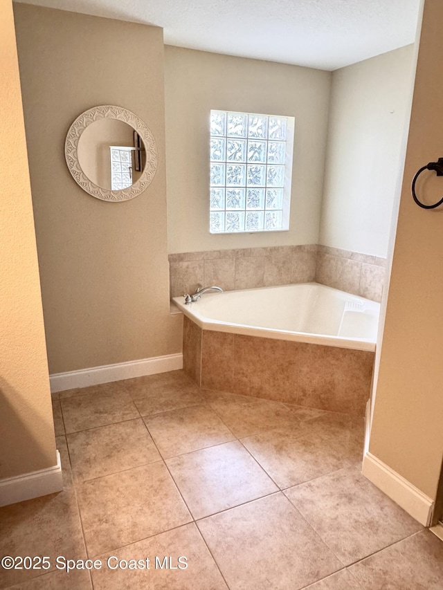 bathroom featuring tiled bath and tile patterned floors