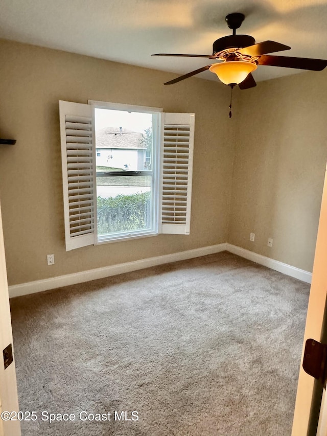 empty room featuring carpet flooring and ceiling fan