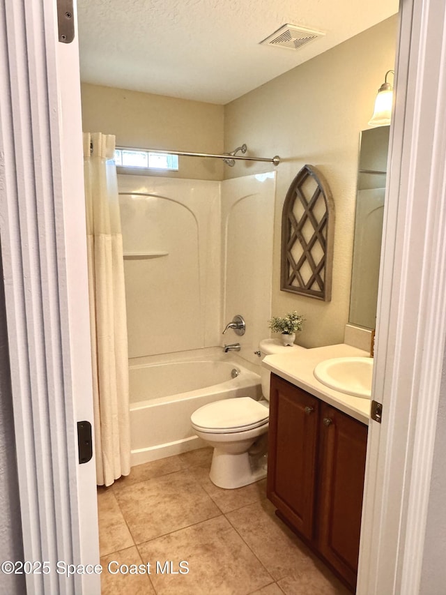 full bathroom featuring shower / bathtub combination with curtain, vanity, a textured ceiling, tile patterned floors, and toilet