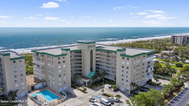 drone / aerial view with a water view and a beach view