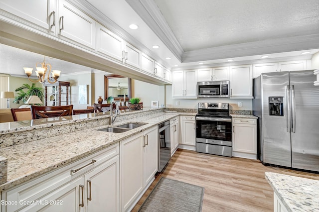 kitchen featuring crown molding, stainless steel appliances, sink, and white cabinets