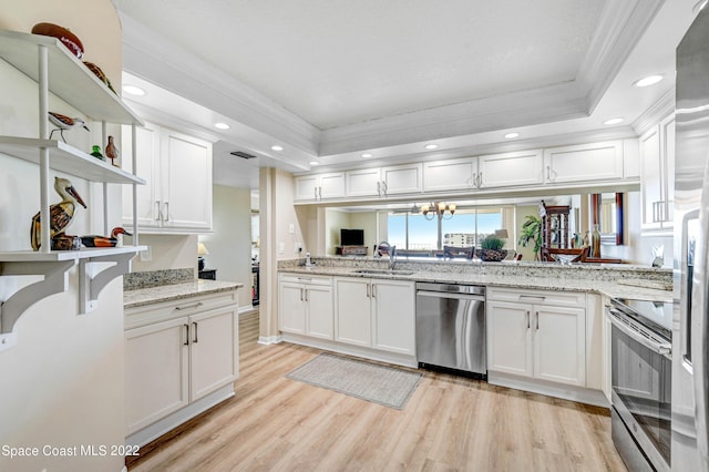 kitchen featuring white cabinetry, sink, a raised ceiling, and appliances with stainless steel finishes