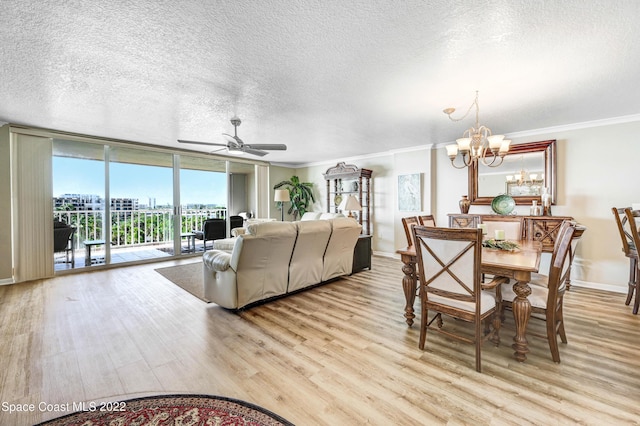 living room featuring ornamental molding, light wood-type flooring, and a wall of windows