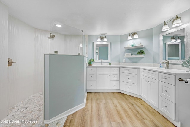 bathroom with vanity, hardwood / wood-style floors, and walk in shower