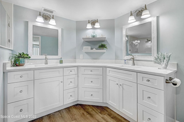 bathroom with vanity and hardwood / wood-style floors