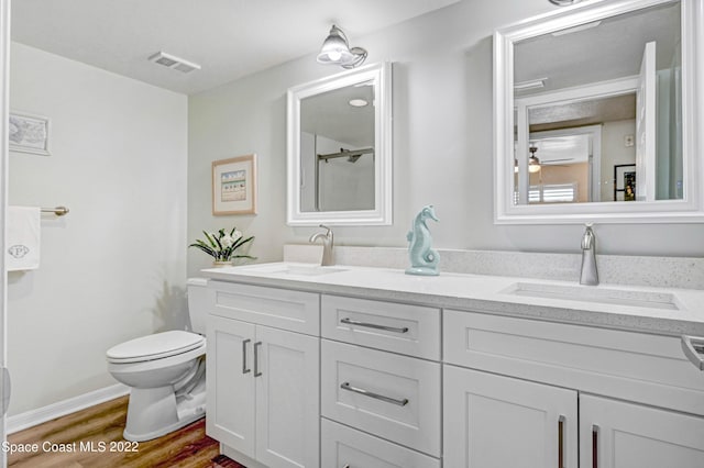 bathroom with vanity, hardwood / wood-style floors, and toilet