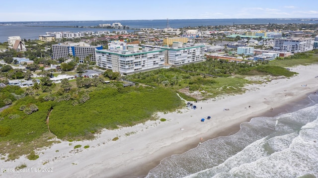 birds eye view of property with a water view and a view of the beach