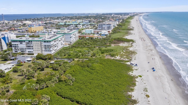 drone / aerial view featuring a view of the beach and a water view