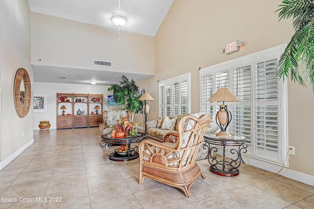 tiled living room featuring high vaulted ceiling