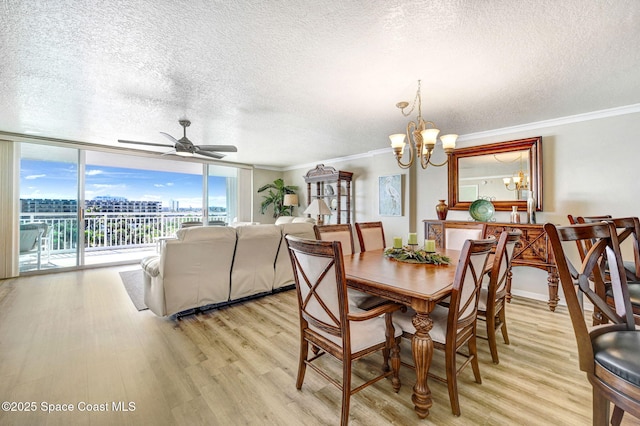 dining area featuring crown molding, floor to ceiling windows, ceiling fan with notable chandelier, and light hardwood / wood-style floors