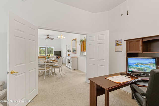 home office with light colored carpet and a notable chandelier