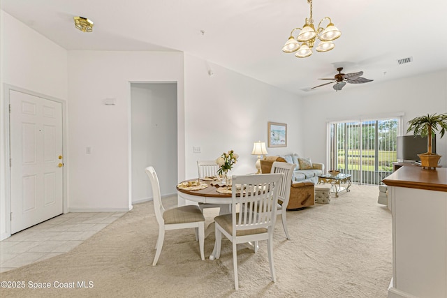 dining area featuring ceiling fan with notable chandelier and light colored carpet